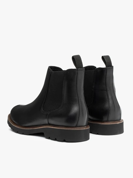 Black men’s Chelsea boots with brown sole edge
