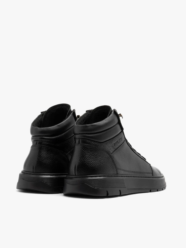 Black sporty men’s boots on a black sole