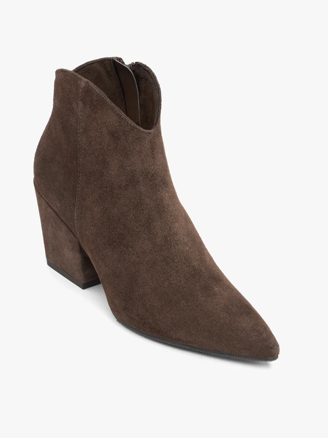 Dark brown cowboy boots on a pole