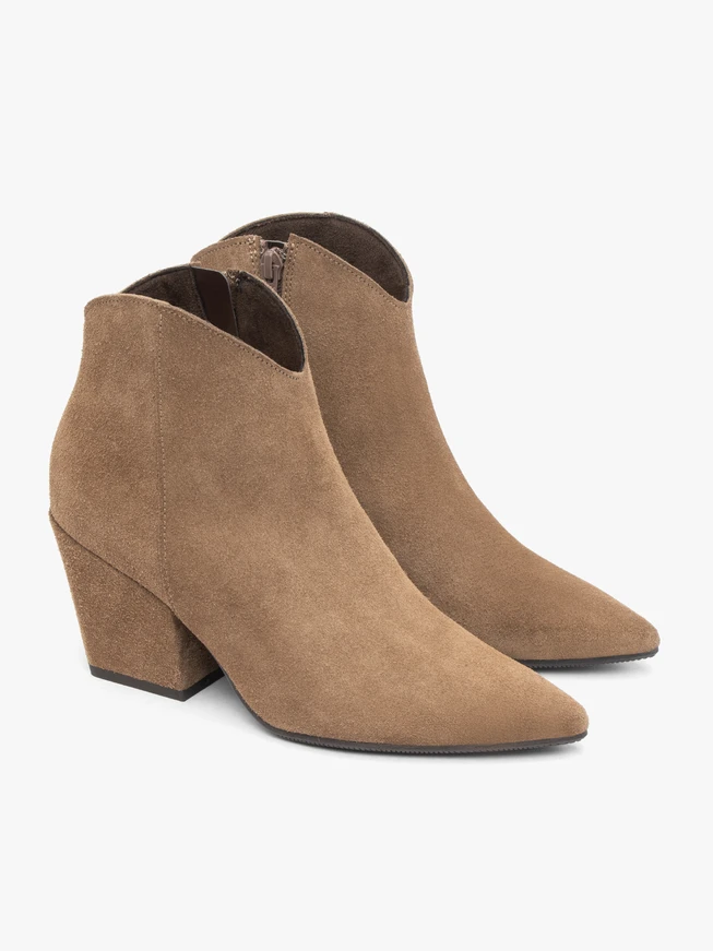 Beige cowboy boots on a pole