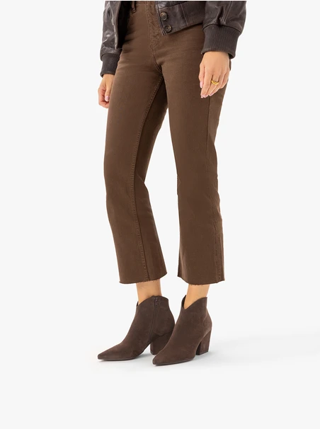 Dark brown cowboy boots on a pole