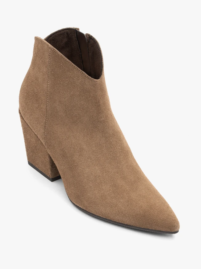Beige cowboy boots on a pole