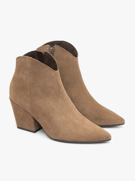 Beige cowboy boots on a pole