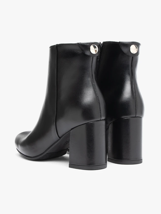 Black leather boots on a post