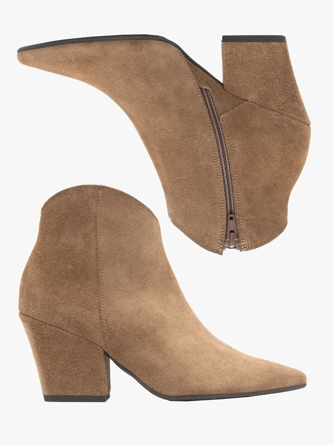 Beige cowboy boots on a pole