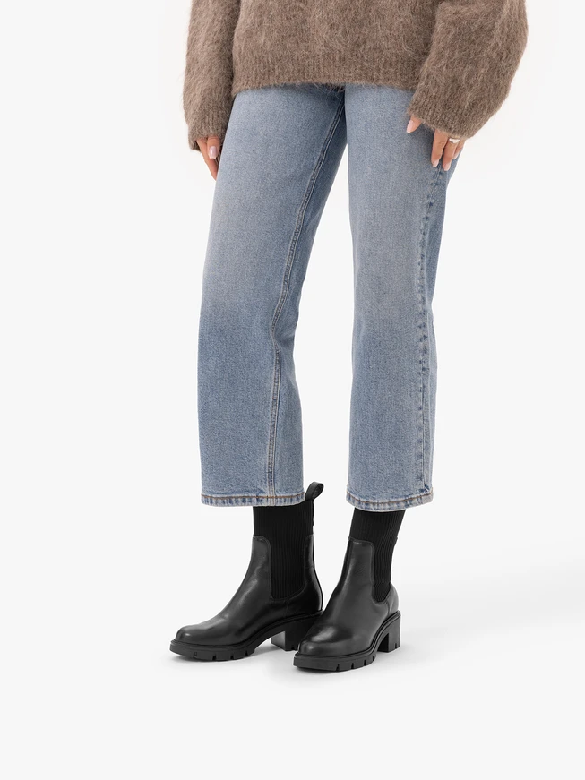 Black high-top ankle boots with a drawstring